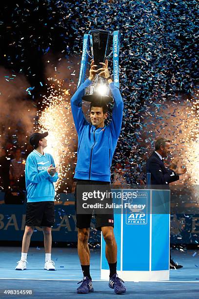 Novak Djokovic of Serbia lifts the trophy following his victory during the men's singles final against Roger Federer of Switzerland on day eight of...