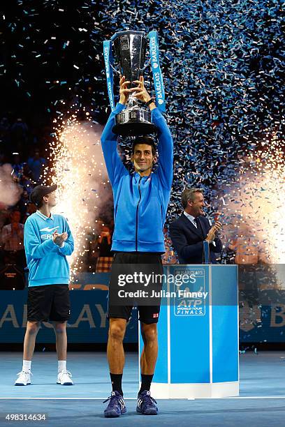 Novak Djokovic of Serbia lifts the trophy following his victory during the men's singles final against Roger Federer of Switzerland on day eight of...