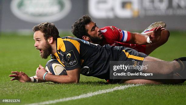 Ruaridh Jackson of Wasps breaks clear of Maxime Mermoz to score a try during the European Rugby Champions Cup match between Wasps and Toulon at the...