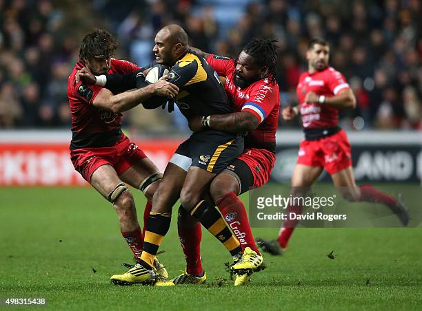 Sailosi Tagicakibau of Wasps is tackled by Juan Fernandez Lobbe and Mathieu Bastareaud during the European Rugby Champions Cup match between Wasps...