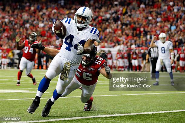 Ahmad Bradshaw of the Indianapolis Colts scores a touchdown against Brooks Reed of the Atlanta Falcons during the second half at the Georgia Dome on...