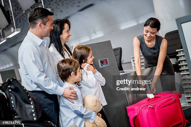 family doing check-in - airport staff stock pictures, royalty-free photos & images