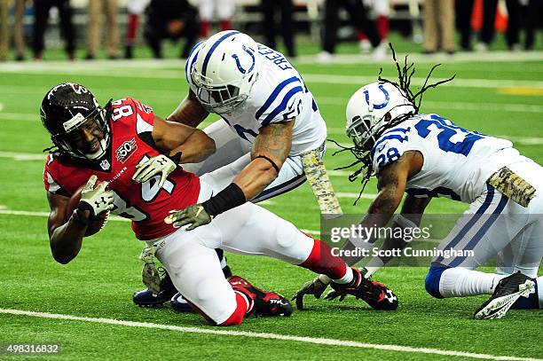 Roddy White of the Atlanta Falcons is tackled by Jerrell Freeman of the Indianapolis Colts after a catch during the first half at the Georgia Dome on...