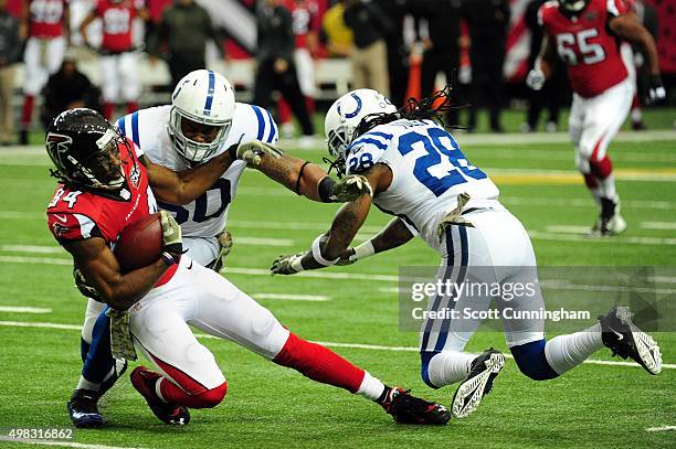 Roddy White of the Atlanta Falcons is tackled by Jerrell Freeman of the Indianapolis Colts after a catch during the first half at the Georgia Dome on...