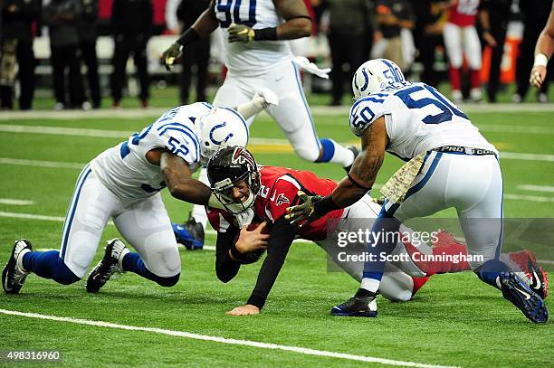 Matt Ryan of the Atlanta Falcons is tackled by D'Qwell Jackson and Jerrell Freeman of the Indianapolis Colts during the first half at the Georgia...