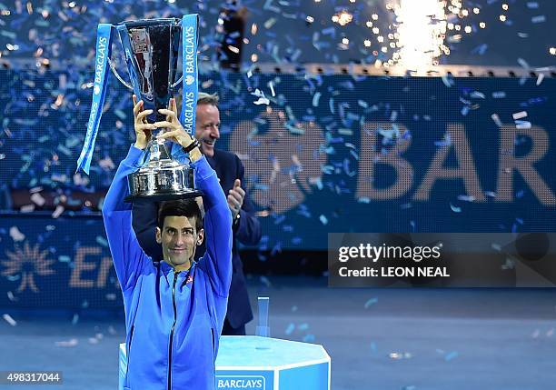 Serbia's Novak Djokovic holds up the ATP trophy after winning the men's singles final match against Switzerland's Roger Federer on day eight of the...