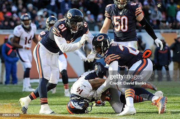 Cody Latimer of the Denver Broncos scores a touchdown against Kyle Fuller and Chris Prosinski of the Chicago Bears in the fourth quarter at Soldier...