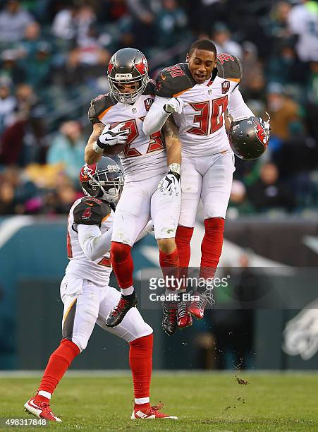 Chris Conte of the Tampa Bay Buccaneers celebrates his interception thrown my quarterback Mark Sanchez of the Philadelphia Eagles with teammate...