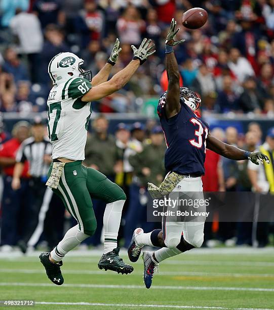 Charles James of the Houston Texans tips the ball away from Eric Decker of the New York Jets at NRG Stadium on November 22, 2015 in Houston, Texas.