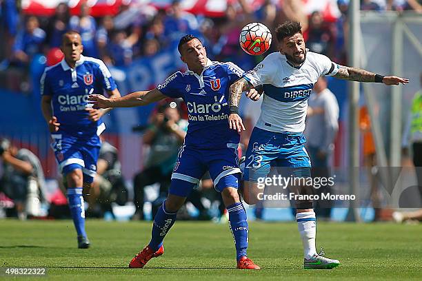 Sebastian Ubilla of U de Chile fights for the ball with Marco Medel of U Catolica during a match between U de Chile and U Catolica as part of 13...