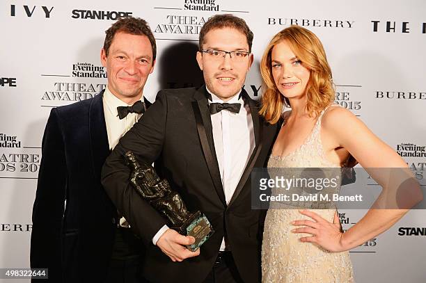 Robert Icke , winner of Best Director for "Oresteia", poses with presenters Dominic West and Ruth Wilson in front of the Winners Boards at The London...