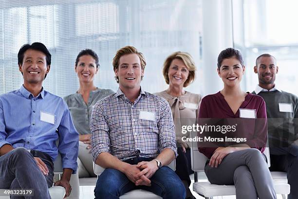 portrait of business professionals at seminar - name plate stockfoto's en -beelden