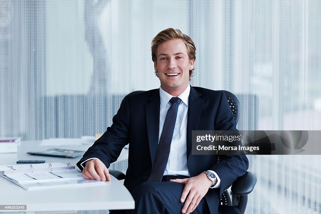 Handsome businessman sitting at desk