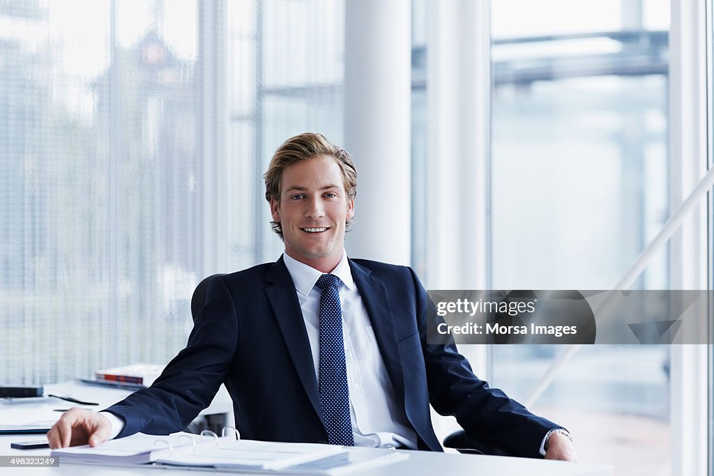 Handsome businessman sitting at desk