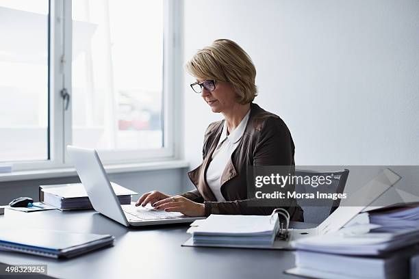 businesswoman using laptop in office - from the desk of stock pictures, royalty-free photos & images
