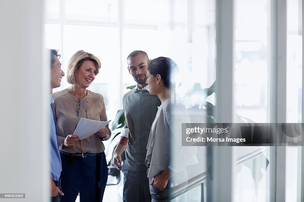 Businesswoman discussing with colleagues