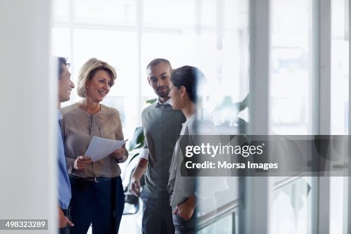 Businesswoman discussing with colleagues Businesswoman discussing with colleagues