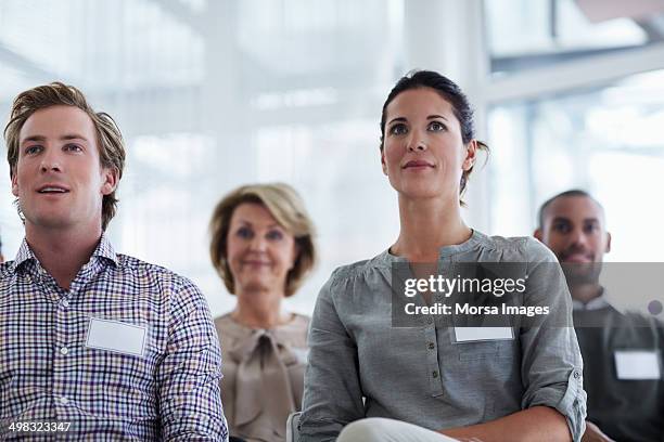 businesspeople listening to seminar - name tag fotografías e imágenes de stock