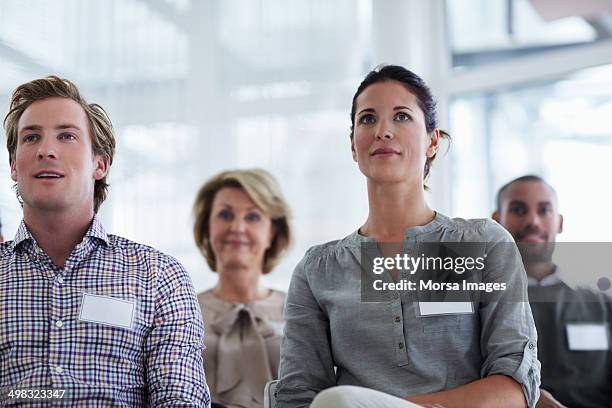 businesspeople listening to seminar - name badge person stock pictures, royalty-free photos & images