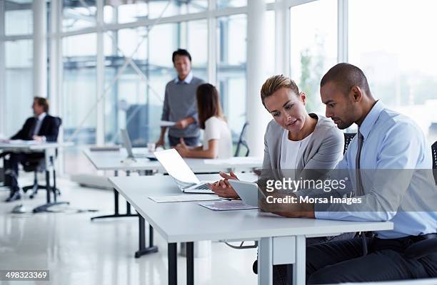 business colleagues using digital tablet - business plan stock pictures, royalty-free photos & images