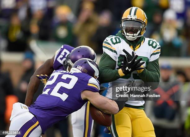 Xavier Rhodes and Harrison Smith of the Minnesota Vikings break up a pass intended for James Jones of the Green Bay Packers during the first quarter...