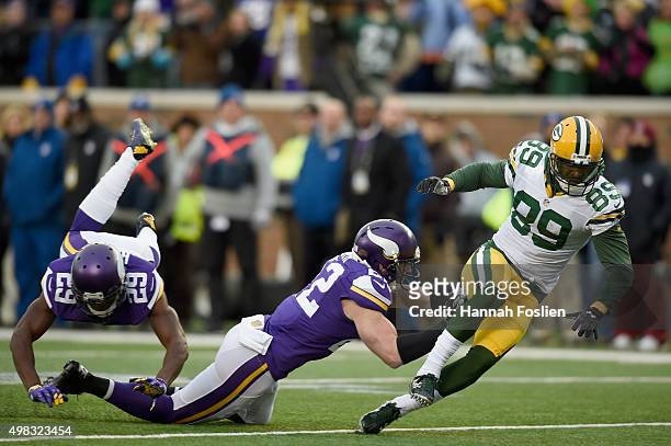 Xavier Rhodes and Harrison Smith of the Minnesota Vikings break up a pass intended for James Jones of the Green Bay Packers during the first quarter...