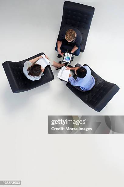 businesspeople discussing over documents - overhead talking stock pictures, royalty-free photos & images