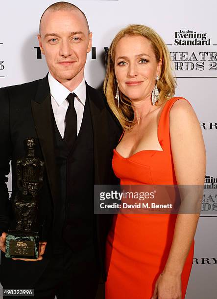 James McAvoy, winner of Best Actor for "The Ruling Class", and Gillian Anderson pose in front of the Winners Boards at The London Evening Standard...