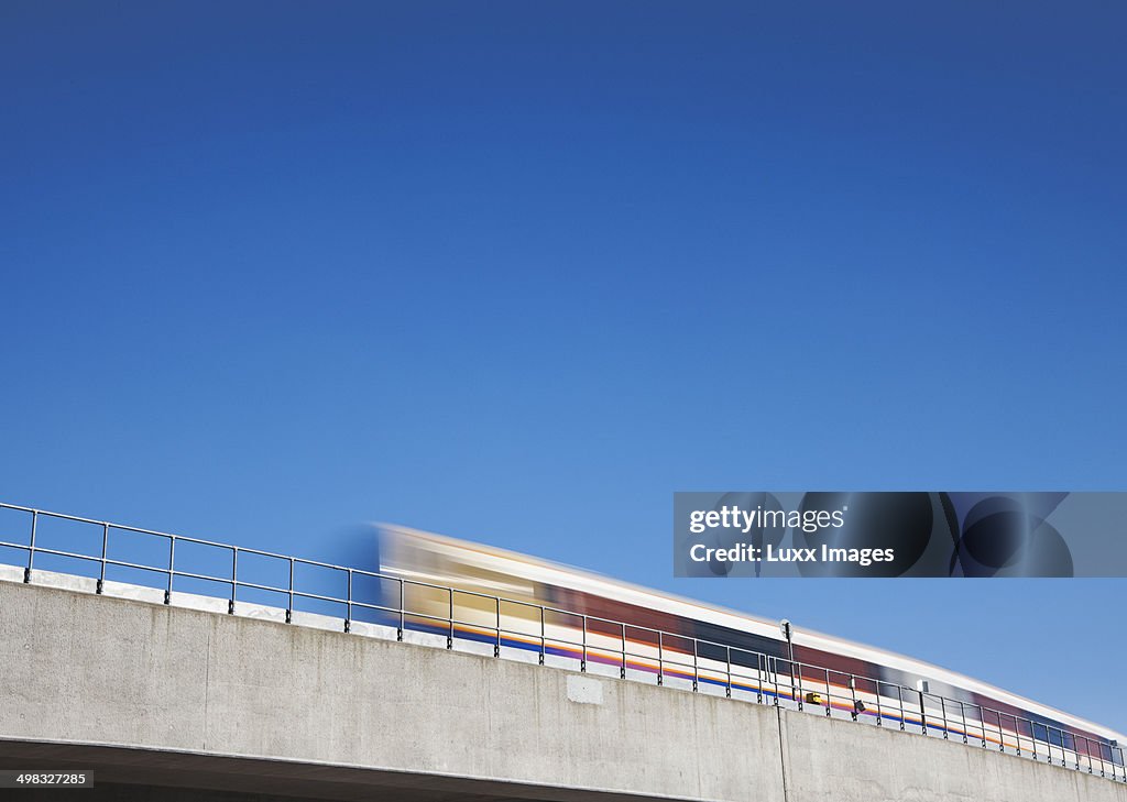 Commuter train travelling across bridge