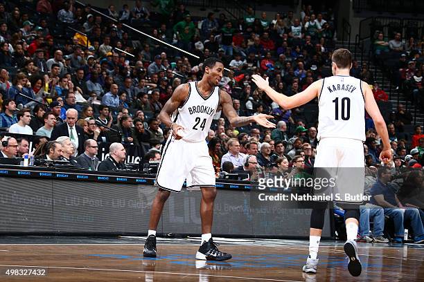 Rondae Hollis-Jefferson of the Brooklyn Nets shakes hands with Sergey Karasev of the Brooklyn Nets during the game against the Boston Celtics on...