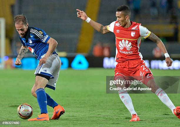 Federico Insua of Millonarios struggles for the ball with Francisco Mesa of Santa Fe during a match between Millonarios and Independiente Santa Fe as...