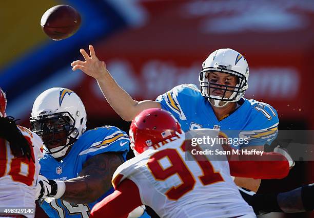 Philip Rivers of the San Diego Chargers passes the ball under pressure from Tamba Hali of the Kansas City Chiefs during the second half of a game at...