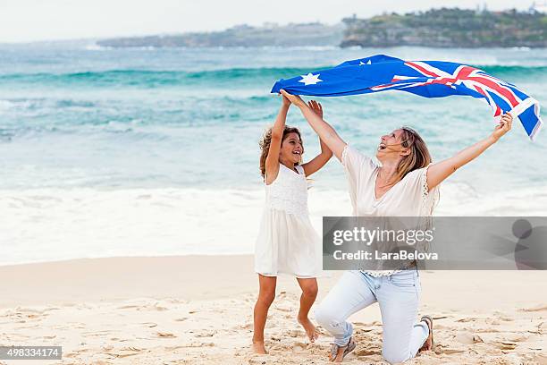 madre y su hija con bandera australiana en la playa - día de australia fotografías e imágenes de stock