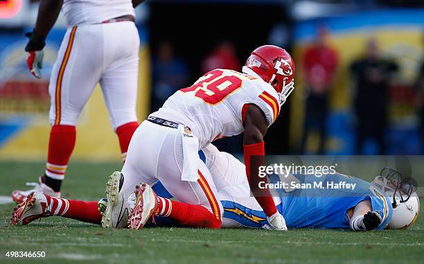 Husain Abdullah of the Kansas City Chiefs looks at Philip Rivers of the San Diego Chargers after tackling him during the second half of a game at...