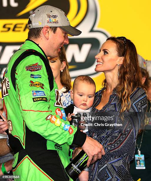 Kyle Busch, driver of the M&M's Crispy Toyota, celebrates with his son Brexton and wife Samantha in Victory Lane after winning the series...