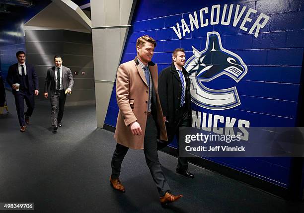 Cory Schneider of the New Jersey Devils and teammate Jiri Tlusty walk to their dressing room before their NHL game against the Vancouver Canucks at...