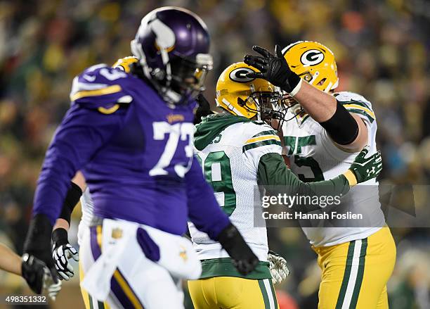 Bryan Bulaga congratulates teammate James Jones on a two-point conversion as Sharrif Floyd of the Minnesota Vikings looks on during the fourth...