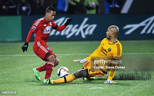 Goal keeper Adam Kwarasey of Portland Timbers slides in on Michael Barrios of FC Dallas during the second half of the match at Providence Park on...
