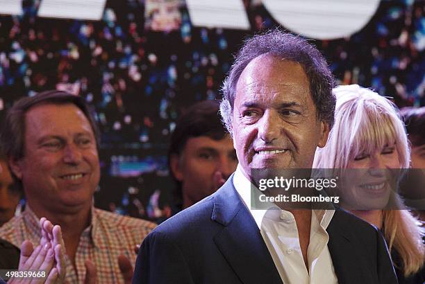 Daniel Scioli, presidential candidate for the ruling party, center, looks on as he speaks to supporters at his campaign headquarters in Buenos Aires,...