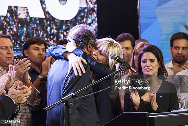 Daniel Scioli, presidential candidate for the ruling party, center left, and his wife Karina Rabolini hug at his campaign headquarters in Buenos...