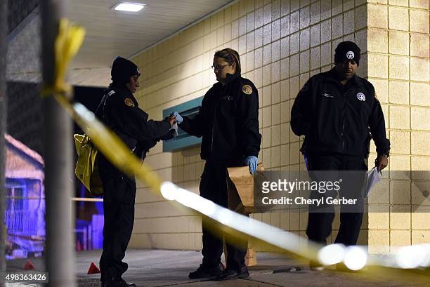 Police gather evidence after a shooting at a playground on November 22, 2015 in New Orleans, Louisiana. According to reports, as many as 16 people...