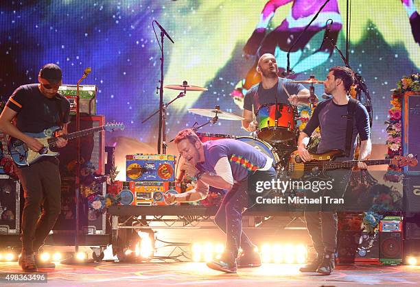 Jonny Buckland, Chris Martin, Will Champion and Guy Berryman of Coldplay perform onstage at the 2015 American Music Awards at Microsoft Theater on...