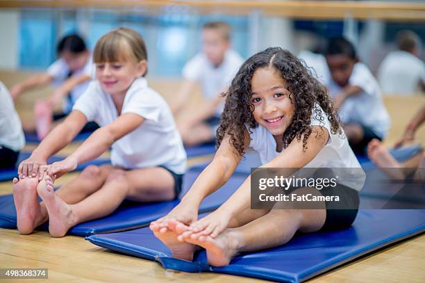 little girl in gym class - acrobat stock pictures, royalty-free photos & images