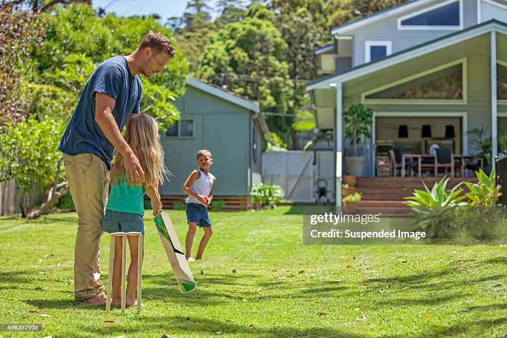 Father teaches daughter cricket