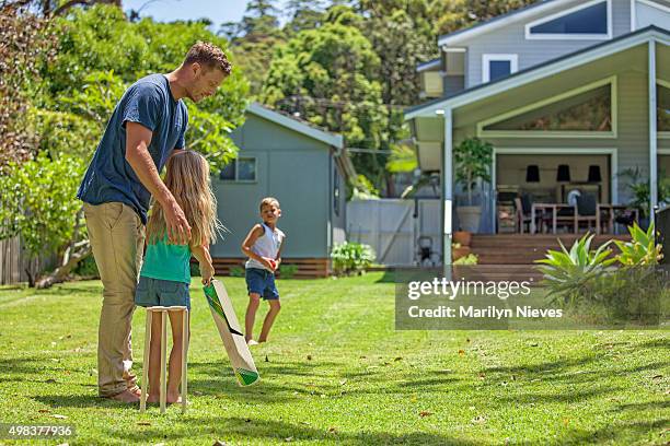father teaches daughter cricket - beach cricket stock pictures, royalty-free photos & images