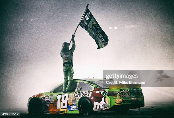 Kyle Busch, driver of the M&M's Crispy Toyota, celebrates winning the series championship and the NASCAR Sprint Cup Series Ford EcoBoost 400 at...