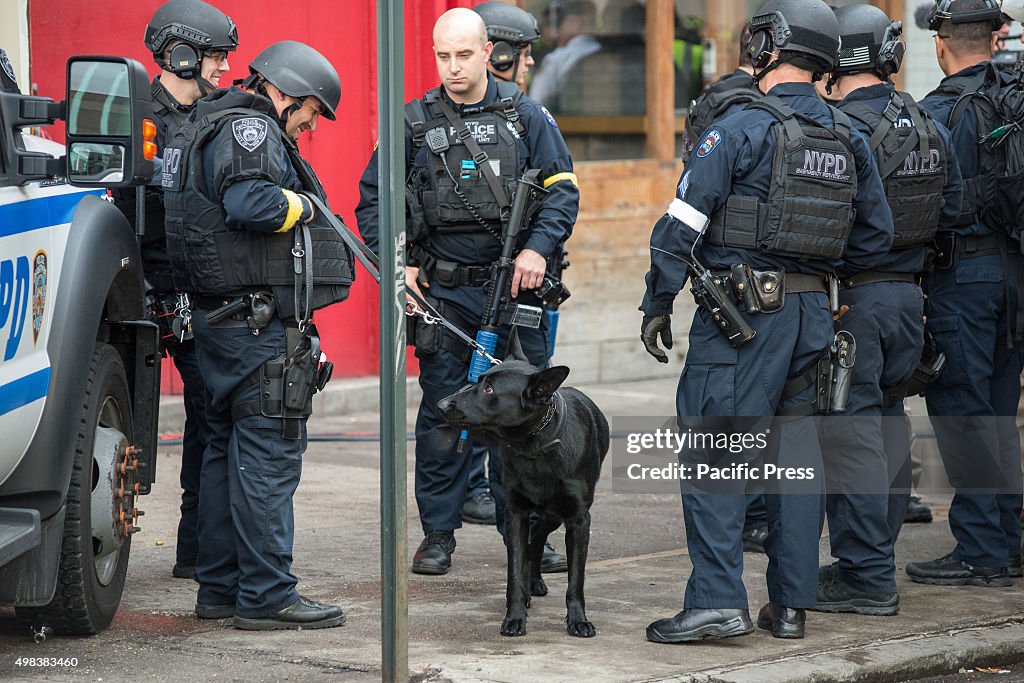 Counter terrorism officers participating in the drill stand...