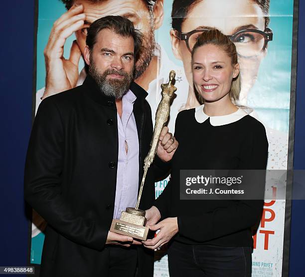 Director/actor Clovis Cornillac and co-writer/actress Lilou Fogli pose for a photo with the 2015 In French Audience Award at the 2015 In French With...