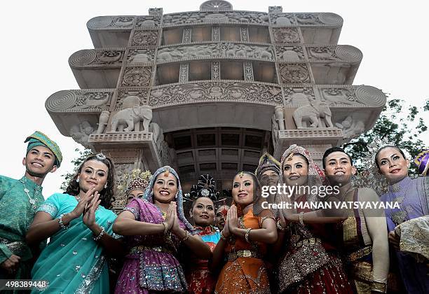 Models dressed in traditional attire pose in front of the "Torana Gate", symbolising Malaysia-India relations after Indian Prime Minister Narendra...