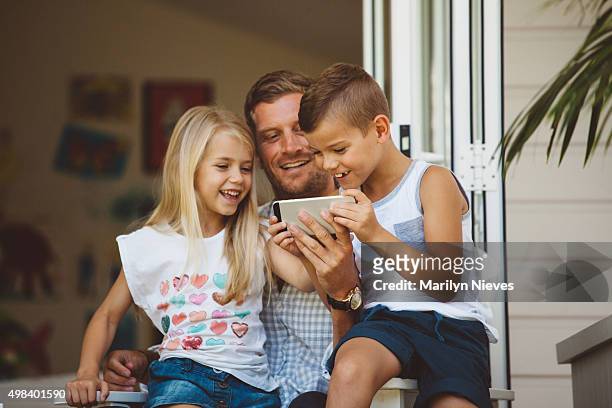 family playing on back porch - australia home stock pictures, royalty-free photos & images